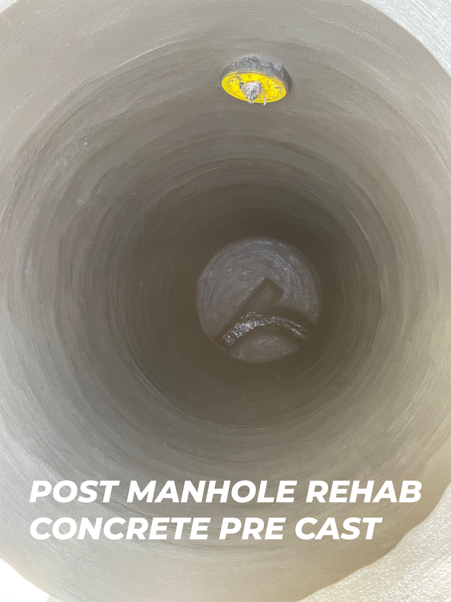 Post-manhole rehabilitation showcasing a concrete pre-cast interior, featuring a yellow access point and smooth, reinforced surface, relevant to sewer infrastructure restoration in Rohnert Park.